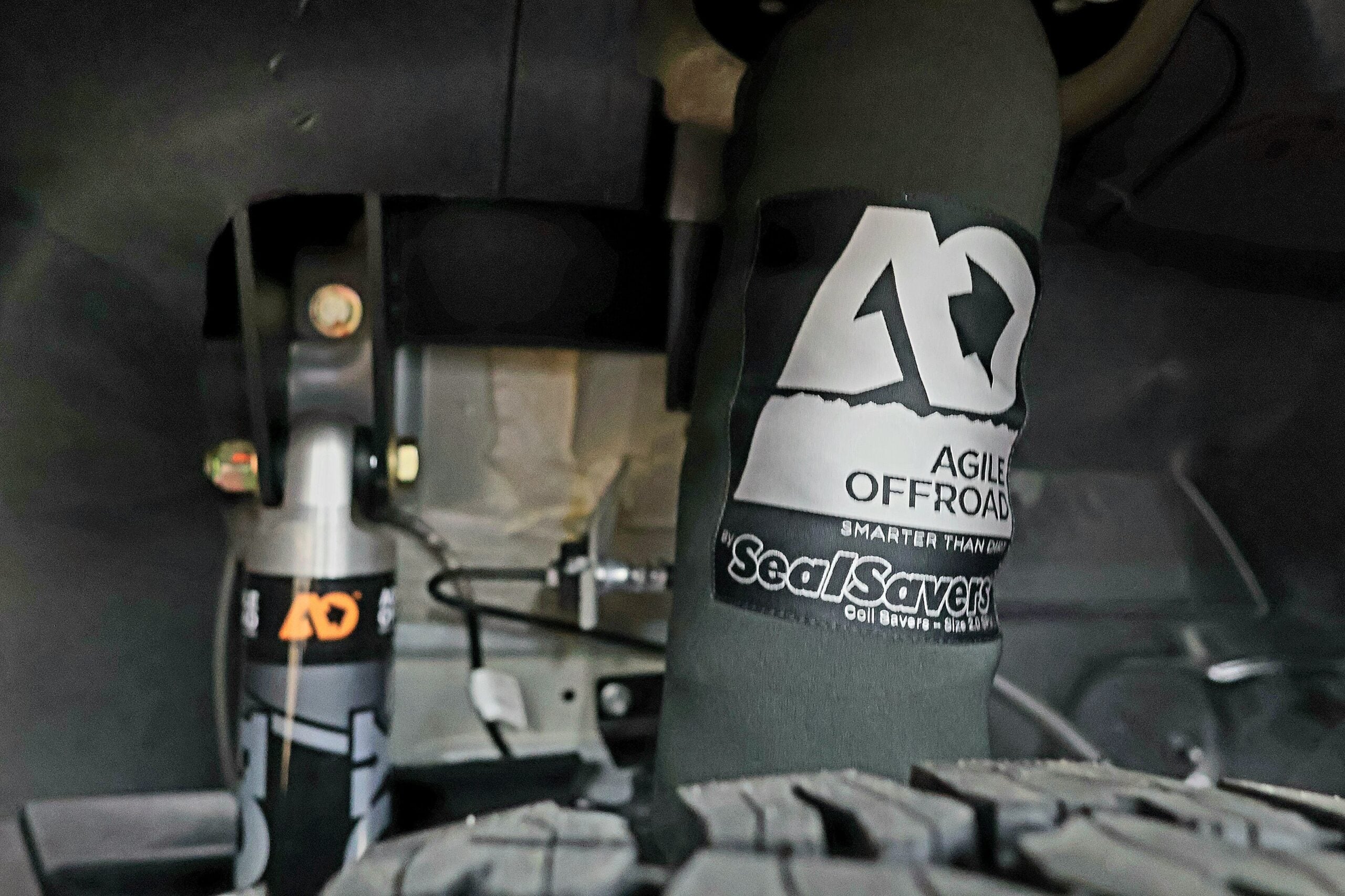 Agile Off-Road shock absorber and Seal Savers coil cover fitted under the chassis of a Mercedes-Benz Sprinter conversion.